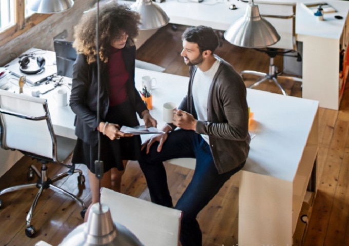 Two colleagues in conversation in an office